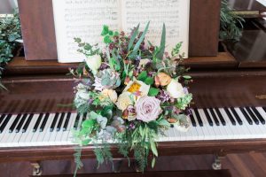 Piano with wedding flowers